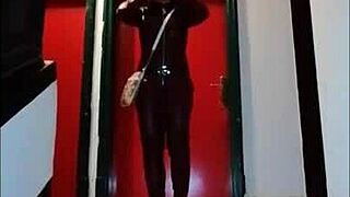 Femdom in leather catsuit and pantyhose with miniskirt