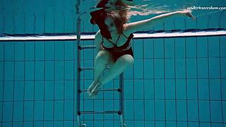 Slender European beauty swims in the pool