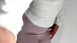 A young woman in sexy pajamas and black stockings masturbates alone