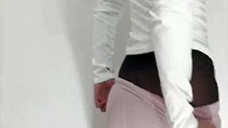 A young woman in sexy pajamas and black stockings masturbates alone