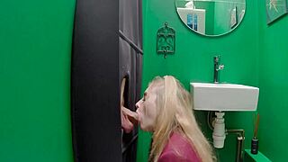 Teenage babe sucks cock through glory hole