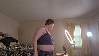 Clara Crisp, a tall milf, preps for a giantess fetish video in hairy backstage action.
