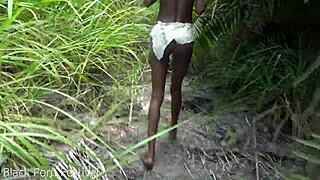 Skinny African tribe woman grinding hard in outdoor tribal work setting